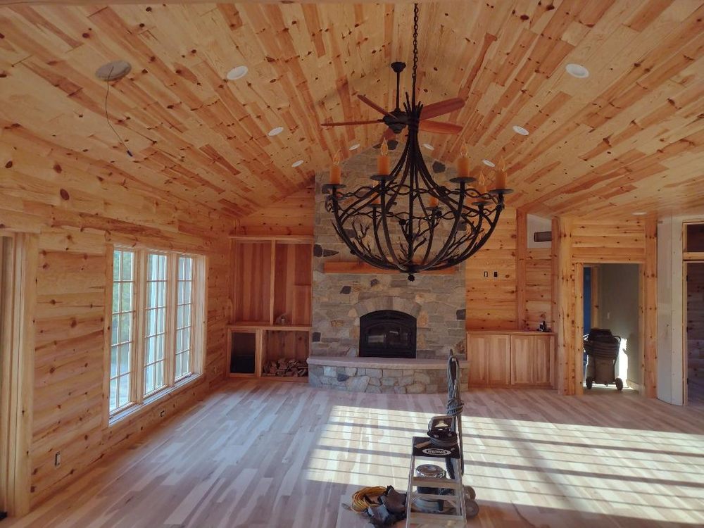 Warm wood great room with a tongue-and-groove ceiling and detailed trim work